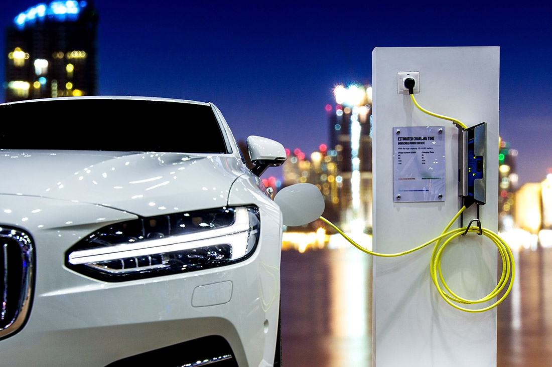 white electric car is charging