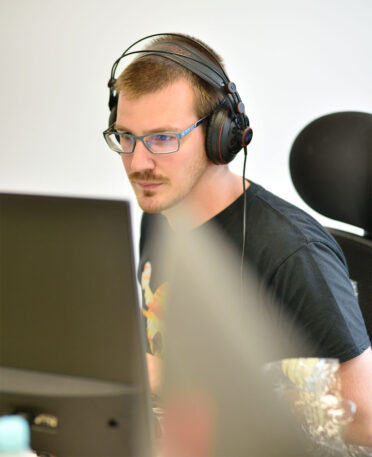 Intern sitting behind desk doing internship at software company