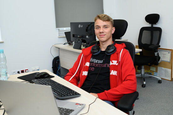 Intern at software company working behind a desk